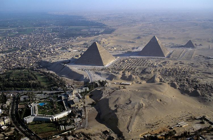 Egypt's Old Kingdom;Giza Plateau; Aerial of the Giza Pyramids (4th dynasty Pharaohs Khufu, Khafre, Menkaure) next to modern city of Cairo