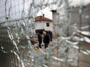 Residents visit the neighborhood where a battle took place over the weekend involving the police and an armed group, in northern Macedonian town of Kumanovo, early Monday, May 11, 2015. (AP Photo/Visar Kryeziu)