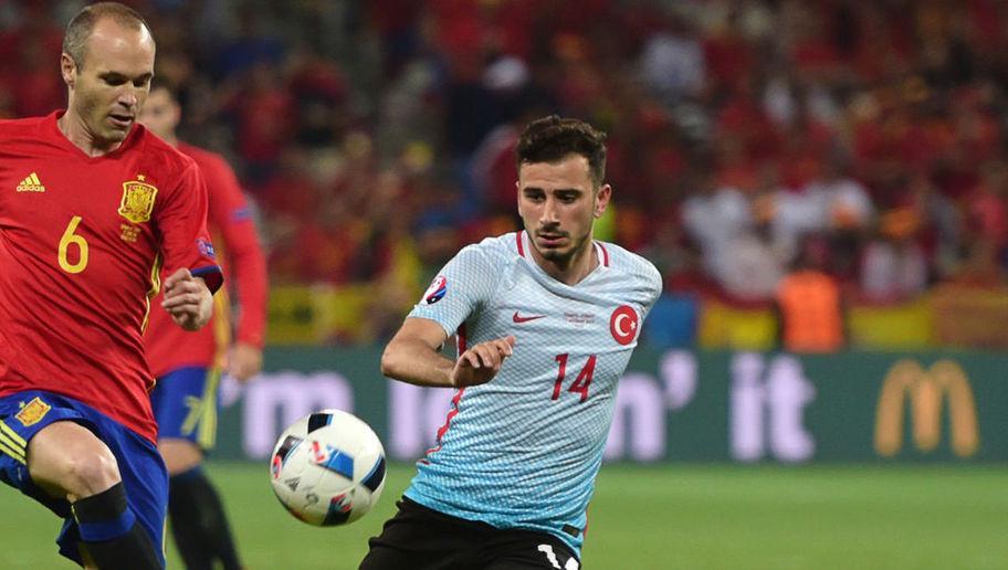 Spain's midfielder Andres Iniesta (L) controls the ball ahead of Turkey's midfielder Oguzhan Ozyakup during the Euro 2016 group D football match between Spain and Turkey at the Allianz Riviera stadium in Nice on June 17, 2016.  / AFP / BULENT KILIC        (Photo credit should read BULENT KILIC/AFP/Getty Images)